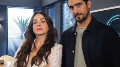 Maya socorrendo Tom após desmaio, com Vênus observando de longe, cheia de ciúmes.