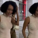 Imagem de Taís Araújo com novo visual como Raquel em Vale Tudo, usando penteado elegante e roupa de alfaiataria.