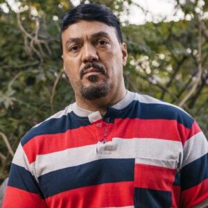 Belo caracterizado como Misael em “Três Graças”, com expressão de sofrimento e determinação.