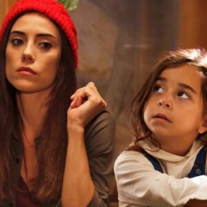 Cena de Mãe, novela turca da Record TV, mostrando a protagonista e a garotinha em momento de afeto e proteção.